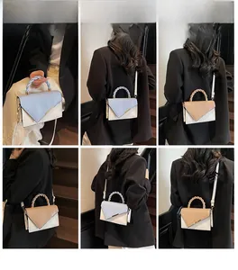 Detail shots of women's woven handle crossbody bag with color block V-flap design