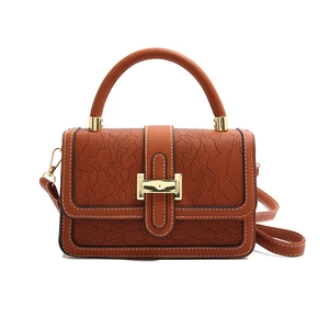 Caramel embossed lace handbag with white contrast stitching and gold lock closure