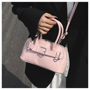 Detail of soft pink shell bag with silver buckle and smooth matte leather texture
