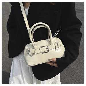 Detail of cream Boston bag featuring silver buckle strap on premium smooth leather