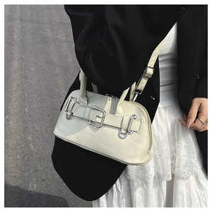 Creamy white shell handbag with vintage metal belt buckle shown on a model