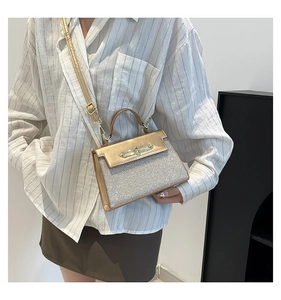 Close-up of metallic gold flap and silver sequin detail on a small crossbody bag