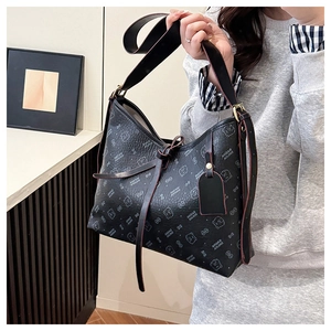 Macro shot of black tote bag featuring cute bear prints and wide shoulder strap detail