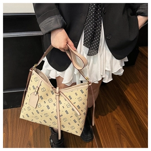 Detail of beige tote bag featuring cute cartoon bear print and decorative leather bow