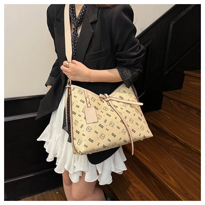 Detail of beige tote bag featuring cute cartoon bear print and stylish bow ribbon tie