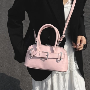 Pink shell handbag with metallic buckle strap and top handle for women's crossbody wear