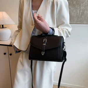 Classic black pebbled leather handbag with silver buckle and adjustable shoulder strap