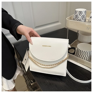 Detail of white leather shoulder bag with golden chain and Fashion & Bags text logo