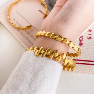 Elegant 18K gold plated heart and oval flower link open bracelets worn on a wrist