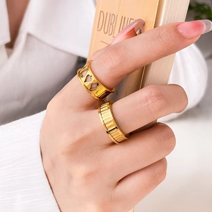 Hollow heart and textured vertical stripe 18K gold plated titanium rings on hand