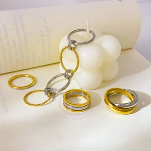 Stackable titanium steel rings in gold and silver, featuring layered and twisted designs