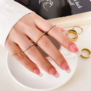 Stackable titanium steel ring set with gold and silver bands in mixed textured designs
