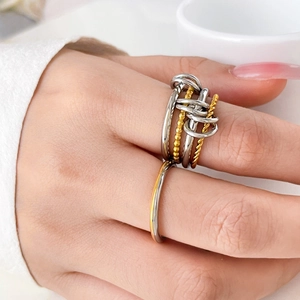 Close-up of mixed metal multi-layered stack ring with gold and silver intertwining bands