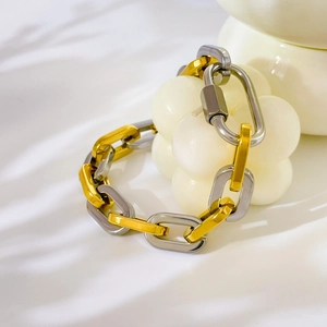 Detail of mixed gold and silver industrial chain bracelet with carabiner screw lock
