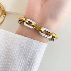Close-up of dual-tone chunky snake chain bracelet in gold and silver finish