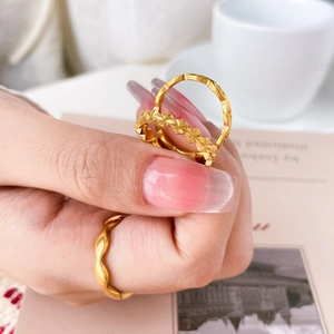 Three-piece stackable 18K gold-plated wavy and floral engraved titanium steel rings set