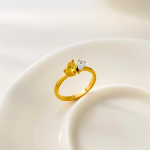 Macro detail of 18K gold plated ring with teardrop yellow and clear zircon stones