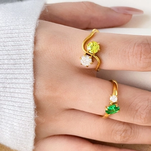 Elegant 18K gold plated rings with yellow and green zircon stones on hands