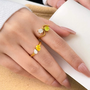 Detail of 18K gold plated titanium rings with round and teardrop colorful zircons
