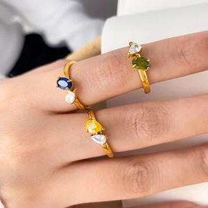 Close-up of three 18K gold plated rings with blue, yellow, and green zircon stones