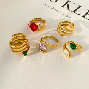 Set of five gold titanium rings featuring snake heads, heart gems and emerald zirconias