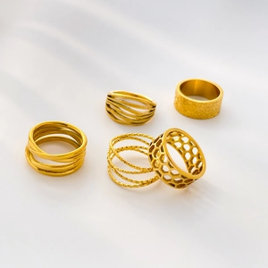 Set of five gold stainless steel rings featuring hollowed, wavy, and hammered texture designs