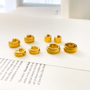 Set of four gold-plated stainless steel chunky hoop earrings with ribbed and smooth finishes