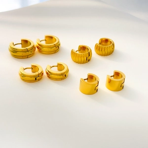 Set of four gold-plated stainless steel chunky hoop earrings with ribbed and smooth finishes