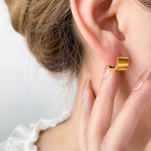 Polished gold-plated stainless steel wide hoop earrings with a glossy pumpkin texture