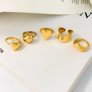 5-piece set of gold titanium steel rings featuring heart shapes and irregular wave bands