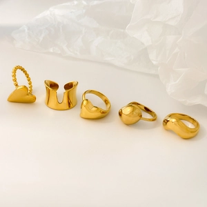 Five-piece set of polished golden stainless steel rings in heart and abstract wave designs