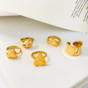 Detail of five-piece minimalist gold rings with irregular sculptural and heart designs