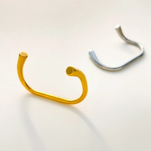 Detail view of interlocking gold and silver titanium steel rings with a polished finish
