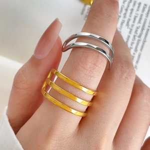 Macro detail of silver double-layered and gold triple-layered polished stacking rings