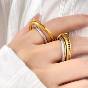 Detail of two-tone titanium steel ring featuring mixed gold silver finish and zircon pavé