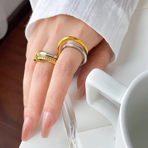 Detail of interlocking two-tone titanium steel rings with pavé cubic zirconia accents