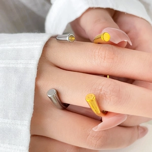 Close-up of minimalist two-tone titanium steel open rings on model's fingers