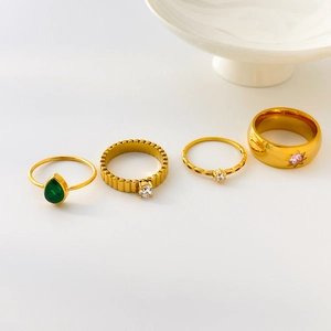 Golden titanium steel ring set with green teardrop zircon and pink star stone gems