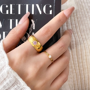 Golden stackable rings with pink starburst stone and thin weave band for women