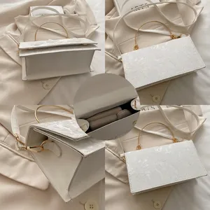 Detailed views of white lace floral crossbody bag with gold handle and interior space