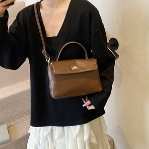 Retro dark brown leather crossbody handbag for women with a gold rotating metal clasp