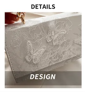 Close-up of white lace texture and 3D butterfly embroidery with gold chain link