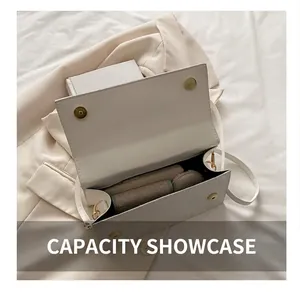 Internal capacity of white leather crossbody bag with magnetic buckle and daily essentials