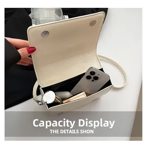 White punk rivet square bag interior view showing capacity for phone and cosmetics