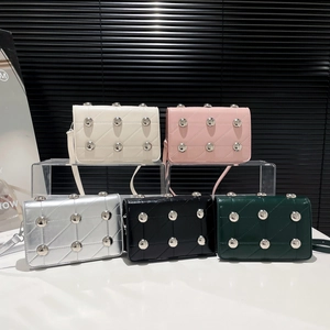 Quilted punk style crossbody bags with metal studs available in five vibrant colors