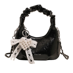 Glossy black pleated cloud hobo bag with pearl heart charm and lace bow details