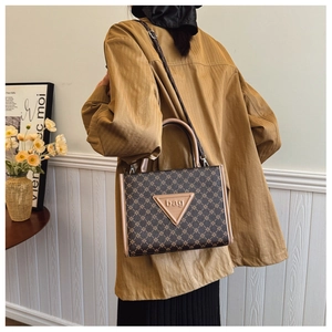 Detail view of large capacity tote bag with geometric star pattern and elegant leather strap