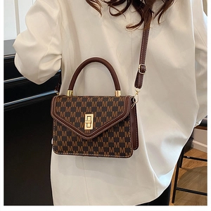 Detail of vintage monogram shoulder bag with gold twist lock and contrast stitching