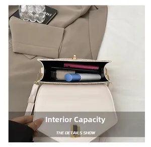 Detailed interior of the beige flap bag showing spacious compartments and storage