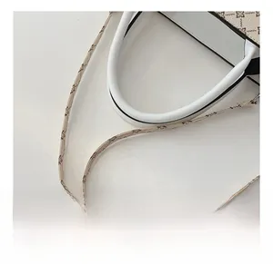 Close-up of stylish floral printed strap and durable handle on off-white tote bag